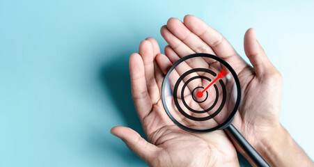 Aufkleber - Business hands holding target icon on magnifier, dartboard and arrow for creative and set up business objective target goal, marketing solution, target for business investment.