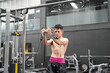 © FotoArtist - Young active athlete exercising on cross training equipment in fitness center or gym