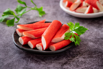 Wall Mural - Fresh crab sticks on black plate