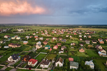 Wall Mural - Aerial view of residential houses in suburban rural area at sunset