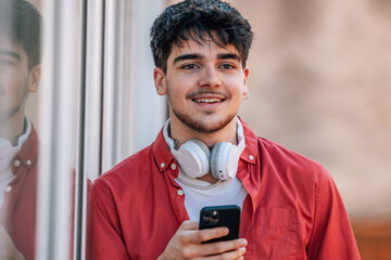 Canvas Print - young man in the street with mobile phone or smartphone