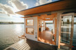 A houseboat with a kitchen and living area on the water. AI generative. Tiny house, houseboat.