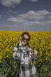 Millennial girl in a shirt on the background of a yellow field.