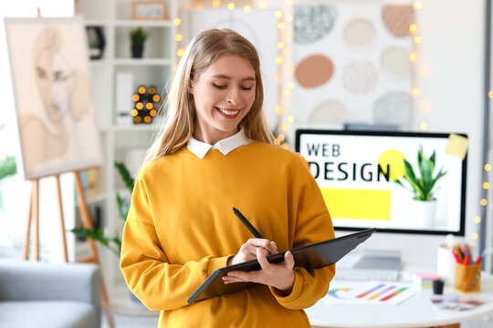 Female graphic designer working with tablet in office
