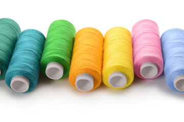 Wall Mural - Set of colorful thread spools on white background, closeup
