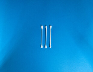 number three (3) in roman numerals with clean white cotton buds isolated on a dark blue background 