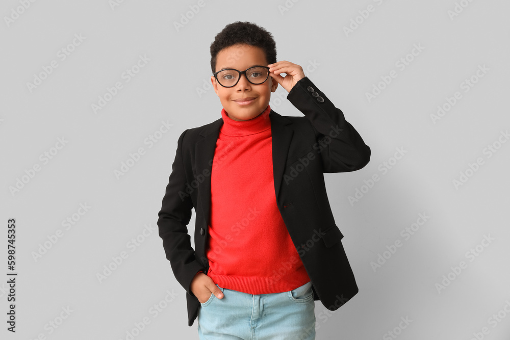 Little African-American boy on light background. Children's Day celebration
