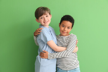 Sticker - Cute little boys hugging on green background