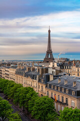 Wall Mural - Eifel Tower against colorful sky and old town building in Paris, France. View from the roof top