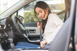 © KMPZZZ - Happy smile brunette asian young woman hand fastens a seat belt sitting in front of car before driving, vehicle for travel, trip take a safe journey, attractive driver with safety belt, transportation