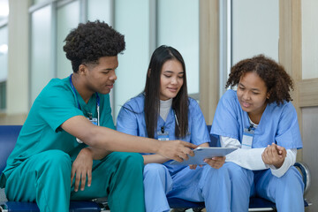 Group of medical student using tablet searching information study and talking in hospital university. education and learning medical concept.