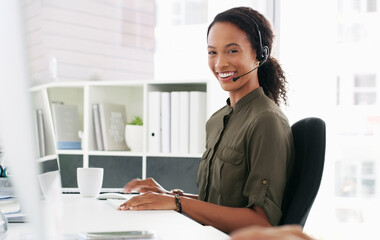Poster - I know just the answer. a young woman using a computer and headset in a modern office.