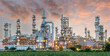 © jutawat - Pipeline and pipe rack of petroleum industrial plant with sunset sky background
