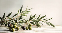 Olive Branch Against A White Wooden Background,