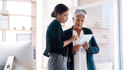 Poster - Success is always their frame of reference. two businesswomen working together on a digital tablet in an office.
