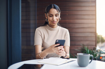 Poster - Gotta reply to this message quickly. an attractive young businesswoman sending a text while working in her office.