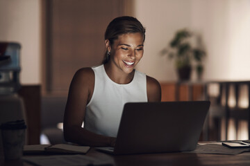 Fototapete - Hard work is the best kind of work. a young businesswoman using a laptop during a late night at work.
