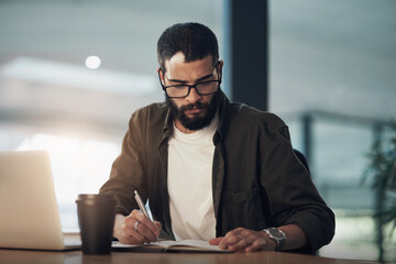 Aufkleber - Work hard and soon youll be writing your on paycheque. a young businessman writing in a notebook and using a laptop during a late night in a modern office.