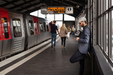 Man With Smart Phone Standing On Railway Station Platform
