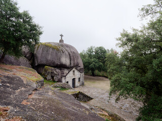 View of Capela Nossa Senhora da Lapa in Portugal. This chapel stands out for its originality, as it was built inside a boulder. Religious place. Christianity. Place of historic and cultural interest. 