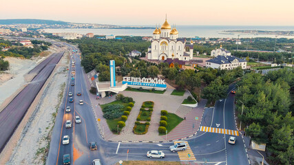 Wall Mural - Gelendzhik, Russia. Cathedral of St. Andrew. The text along the M4-Don Highway is translated: Glory to Russia, Kuban-Pearl of Russia. Gelenzhik-City Resort. Sunset, Aerial View