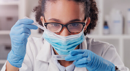 Wall Mural - science is about seeing how things react. a young scientist analysing samples in a lab.