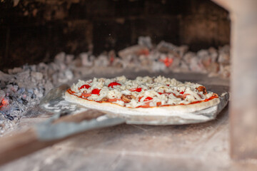 Aufkleber - Cooking real pizza in a brick oven. Wood and fire are burning in the stove.