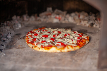 Aufkleber - Cooking real pizza in a brick oven. Wood and fire are burning in the stove.