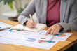 © Charlie's - Calculating Cost Economic budget saving and investment concept analyzing investment charts and calculator Accounting Concept