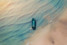Top View Of Fishing Boat At Low Tide In The Afternoon