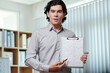 © DragonImages - Serious entrepreneur pointing at chart in his hands and explaining development strategy