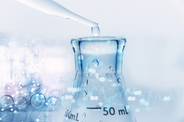 Wall Mural - water drop with pipet in to glass flask in blue medical research science laboratory and graph inform