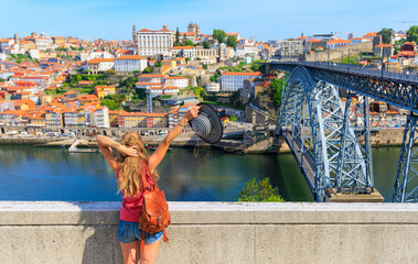 Wall Mural - woman tourist enjoying view of porto cityscape and bridge- portugal