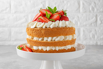 Strawberry cake, vanilla sponge cake with cream cheese and fresh strawberries. Summer cake. Selective focus.