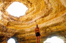 Benagil Cave In Portimao Portugal And Woman Tourist