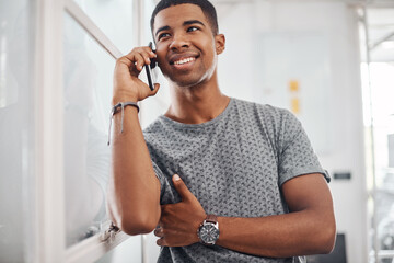 Sticker - Hey man, how have you been. Portrait of a young businessman talking on a cellphone in an office.