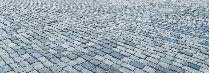 Wall Mural - The texture of a stone old pavement with a perspective.