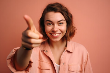 Wall Mural - Portrait of beautiful young woman showing thumbs up on pink background. Generative AI