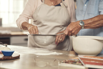 Canvas Print - What are we baking today. an unrecognizable couple baking together at home.