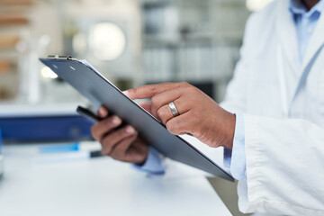 Poster - Taking a closer look at the records. Closeup shot of an unrecognisable scientist holding a clipboard in a lab.