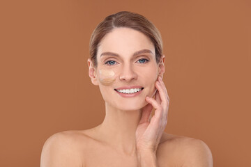 Poster - Woman with swatches of foundation on face against brown background