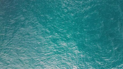 Sticker - Sea surface top down aerial view. Camera flies over the water surface with waves and ripples Generative AI