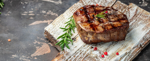 Wall Mural - filet Mignon with a piece of butter on a wooden board. Long banner format. top view