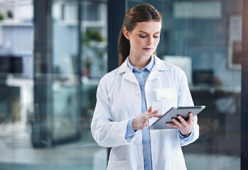 Aufkleber - She has lots to check up on. a young female doctor using a digital tablet in a hospital.