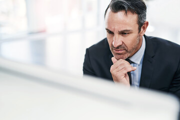 Aufkleber - Ensuring all his plans fall into place. a mature businessman working on a computer in an office.