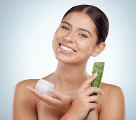 Canvas Print - Portrait of smiling beautiful woman using aloe vera in skincare routine. Caucasian model isolated against grey studio background and posing with copyspace. Organic plants for hydration and moisture