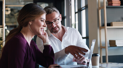 Aufkleber - Collaboration that keeps the progress coming. a businessman and businesswoman using a laptop and having a discussion in a modern office.