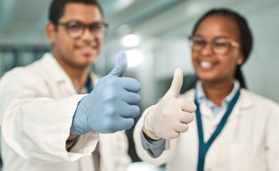 Wall Mural - we just cracked the case. two scientists showing thumbs up in a lab.