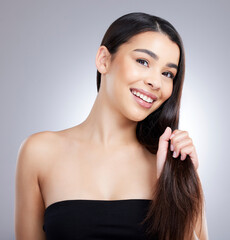 Poster - My hair is so full of strength and moisture. Studio portrait of an attractive young woman posing against a grey background.