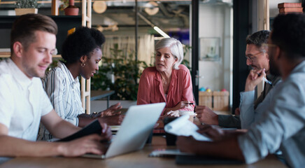 Poster - Meet up and maximise on success. a group of businesspeople having a meeting in a modern office.
